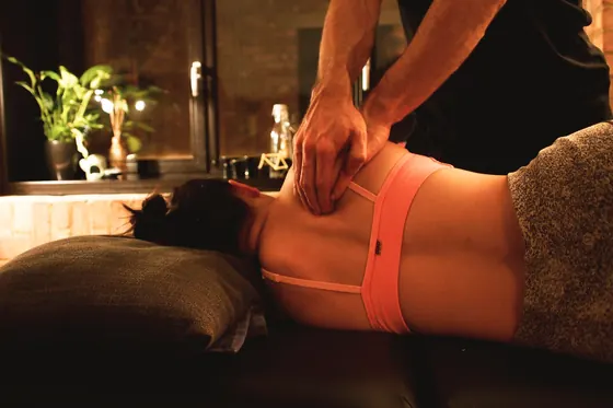Deep tissue massage on a client's lower back